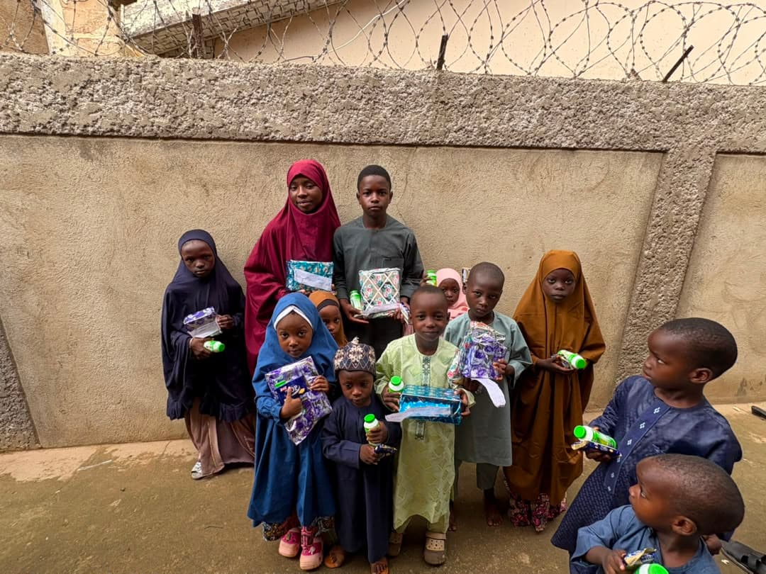 Children holding gift packs from the foundation