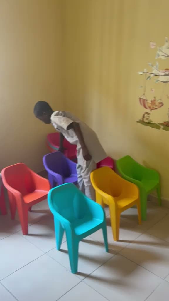 Small children in a colourful early-years classroom