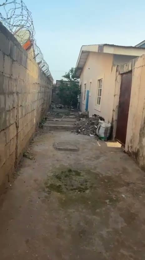 An unfinished compound with rubble along the walls